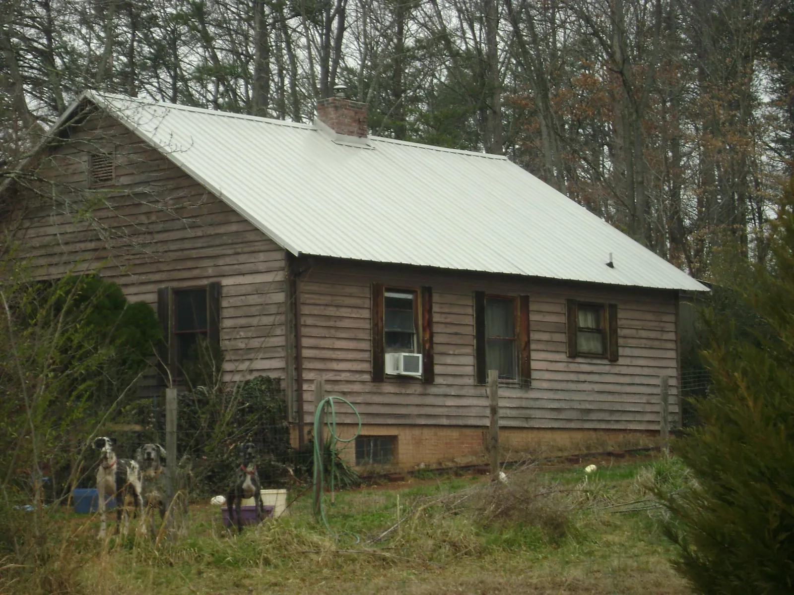 White metal roof on an old wood sided farmhouse, from a Metal Roof Installation job in Fowler